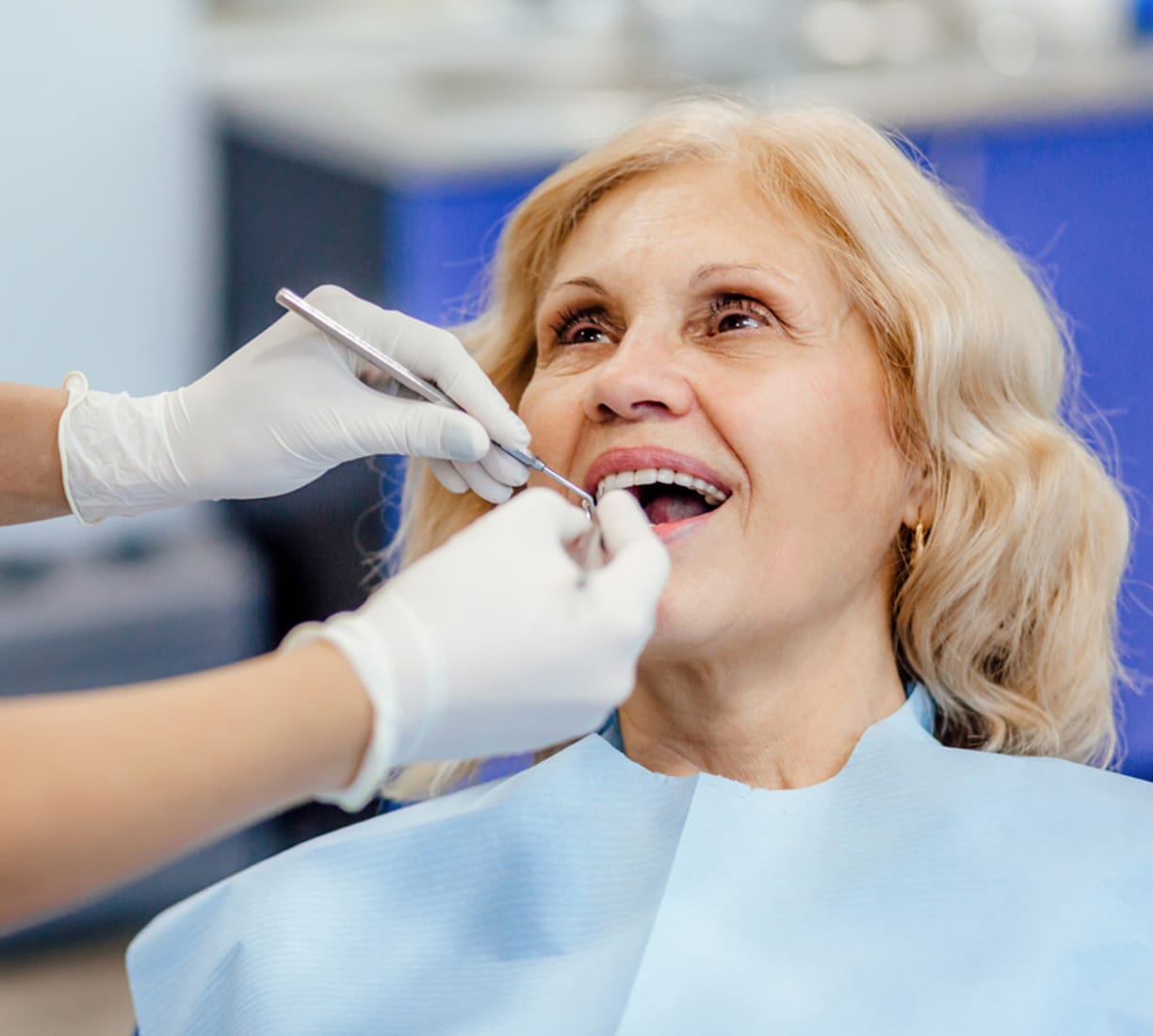 Dentist cleaning a woman's teeth