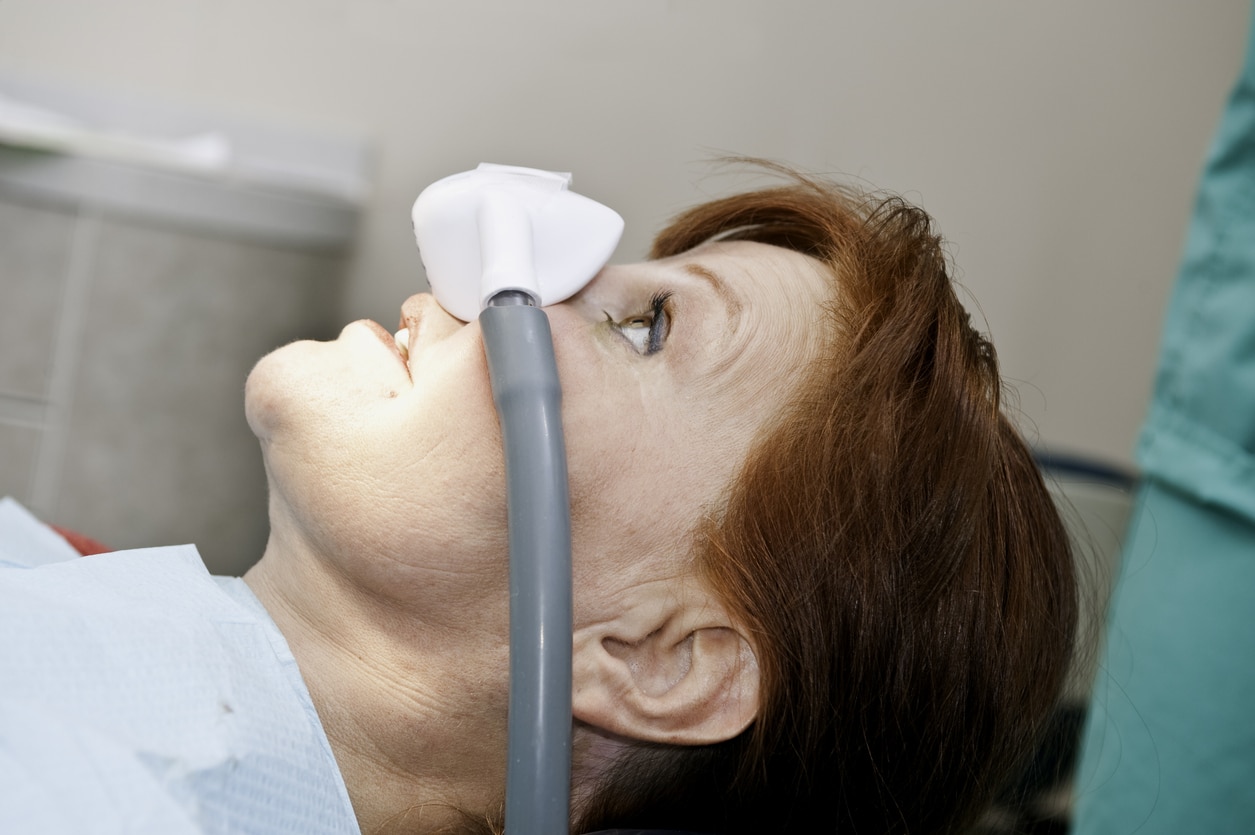 Woman being sedated for her dental treatment