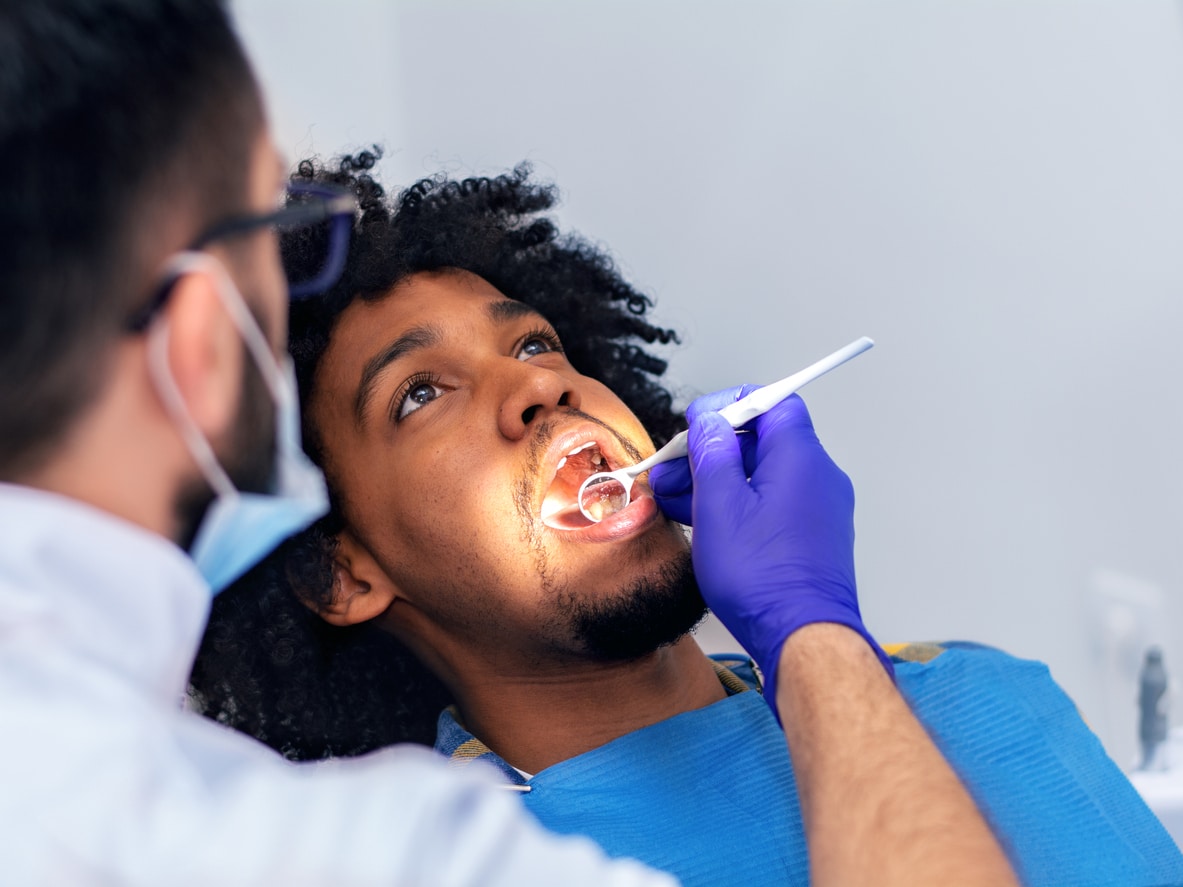 Dentist examining a man's teeth