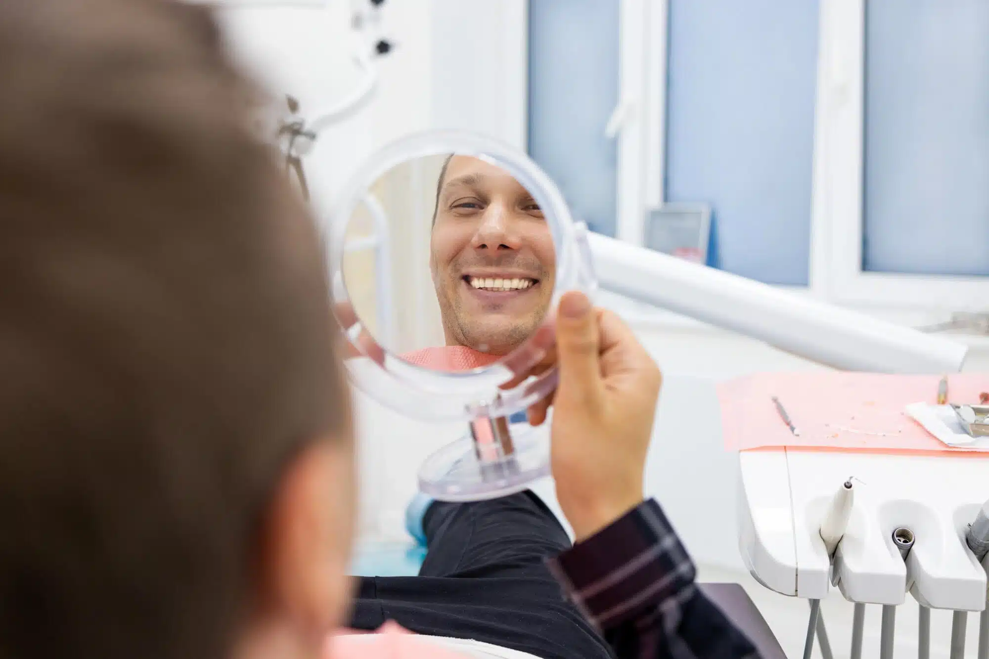 Man checking his dental implants detroit mi 